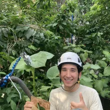 Photo of student with sensor on leaf.